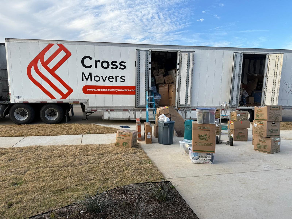Movers unloading a Cross Country Movers truck