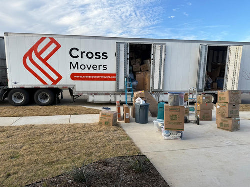 Movers unloading a Cross Country Movers truck